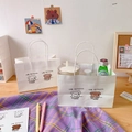 White gift bag with cute cartoon dog illustration and sturdy handles in a cozy setting - 1# Cute Puppy