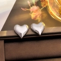 Polished silver heart stud earrings shown on dark velvet display background - 45# Grey Heart Studs