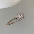 Detailed macro view of silver star hair clip with pink aurora stone and rhinestones - Single Star / Silver