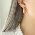 Elegant U-shaped gold earrings with embedded pearls shown on a female model - Gold (F666)
