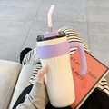 White stainless steel tumbler with purple silicone sleeve and handle in a lifestyle setting - White 860ml