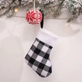 Close-up of black and white plaid Christmas stocking with white plush trim on tree - Small Black and White Plaid Stocking