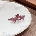 Y2K style butterfly hair clip with pink rhinestones on a decorative white tray - Double Butterfly / Rose Red