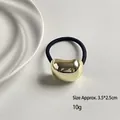 Elastic hair tie with a 3.5x2.5cm gold-toned geometric metal bead in mirror finish - Short Oval Gold
