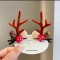 Detail of Christmas reindeer antler hair clips with pine cones and plush balls - Brown Antlers with Pine Cone & Mushroom Pair