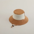 Close-up of contrast stitching and adjustable windproof cord on kids retro bucket hat - 2-5 Years Old / Coffee Patchwork
