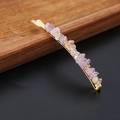 Detail of natural purple crystal stone hairpin on golden metal base over wood surface - Ametrine Gold