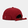 Detailed close-up of a red canvas miki hat featuring white C letter embroidery and metal buckle - Dark Red