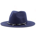 Detailed close-up of dark blue straw fedora hat featuring beaded band and silver feather charm - Navy Blue