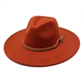 Detailed texture of burnt orange wool fedora hat with brown leather band and gold buckle - M / Caramel color