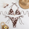 Flat lay of floral bikini with halter top, side-tie bottom and summer accessories - S / Coffee