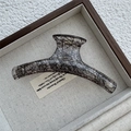 Detail showing high-quality black lace mesh pattern inside translucent amber hair claw clip - Linear / Black