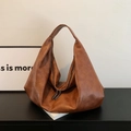 Brown faux leather hobo bag with a soft slouchy design and double zippers on the desk - Brown