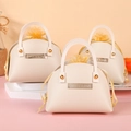 Three beige leather wedding favor bags with gold accents and yellow drawstring pouch - Beige
