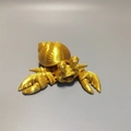 Detailed view of the 3D printed articulated hermit crab toy in a metallic gold finish - Hermit Crab / Silk Gold