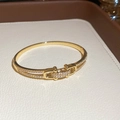 Vue détaillée du bracelet jonc doré avec fermoir géométrique et pavage en zircons brillants - Style Boucle Manille (6012643128196)