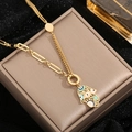 Detail der goldenen Hand der Fatima Halskette mit blauem Auge auf einem Schmuckkästchen - Emaille Böser Blick Hamsa Hand Halskette Gold