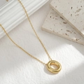 Minimalist thick gold oval pendant necklace on elegant textured stone background - Letter O