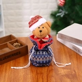 Christmas blue knit drawstring bag with a 3D plush bear wearing a festive hat and scarf - Knitted Bear Bag