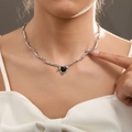 Minimalist silver chain necklace with a black heart pendant on a female model - Silver Chain Black Heart Pendant Necklace