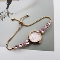 Detail of gold watch bracelet with pink heart gemstones and mother of pearl dial - Rose Gold Pink