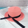 Detailed view of pink woven straw boater hat with black dotted ribbon embellishment - M (56-58cm) / Pink