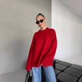 Oversized red crew neck knit sweater for women paired with blue jeans in a modern room - S / Red