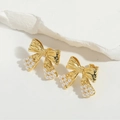 Elegant gold bow earrings with white pearl accents on minimalist white stone - Gold Bowknot with Small Pearl