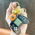 Porte-clés Capybara mignon avec mini console de jeu rétro et clochette dorée poli - Machine De Jeu Kapibala - Noire