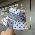 White bucket hat with black paisley pattern and durable cotton canvas material - One Size / White