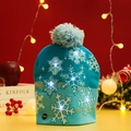 Detail of teal knitted Christmas hat with white snowflake patterns and LED power switch - Snowflake Style