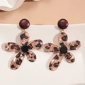 Detailed close-up of leopard print resin flower earrings on a white wavy stand - Silver Needle-Dark Gold