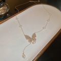 Detail of gold plated butterfly pendant necklace with freshwater pearls and zircons - Gold (Butterfly Artificial Pearl Chain)