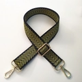 Detail of wide black shoulder strap with yellow chevron pattern and gold metal hardware - Gold Thread Arrow