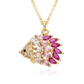 Macro shot of gold hedgehog pendant with marquise-cut pink and white crystals - Multicolor Hedgehog