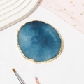 Detailed top view of blue resin agate nail palette with gold trim on white desk - Dark Blue