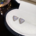 Close-up of sparkling silver triangle stud earrings with zircons in a jewelry box - Stud Earrings (With Silver Pin) / Silver
