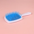 Vented detangling hair brush with white handle and blue bristles on pink background - White Handle + Blue