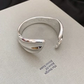 Macro detail of silver wide cuff bracelet with polished wavy edges on a book cover - Irregular Wave Silver (6# Bracelet)
