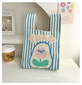 Knitted stripe bucket bag in beige and blue featuring a pink flower embroidery - Flower Pink