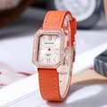 Detailed close-up of rectangular rose gold watch with orange leather strap and crystal bezel - Orange