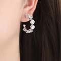 Silver C-shaped titanium earrings with seven square-cut zircons on a model - Silver