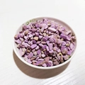 Polished natural purple and brown crystal gravel in a white ceramic bowl for DIY decor - Phosphosiderite