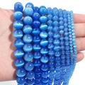 Detailed view of blue cat eye stone beads in various sizes for DIY jewelry making - Sapphire Blue