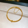 Detailed close-up of 24K gold plated bead bracelet with central charm and safety chain - Spiral Texture Transfer Bead Bangle - Gold