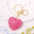 Detailed view of pink rhinestone heart keychain with gold ring on a lifestyle background - Full Rhinestone Pink Heart
