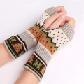 Close-up of thick knitted fingerless gloves with colorful ethnic jacquard patterns - One Size / Light Gray