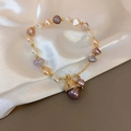 Detailed macro view of French style irregular pearl bracelet with gold lucky cat charm - 28# Bracelet-Gold-Lucky Cat