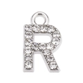 Close-up of silver letter R pendant with sparkling rhinestones and metal loop - Letter R