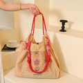 Apricot nylon tote bag with colorful embroidery and red rope handle in a lifestyle setting - Beige Colorful Paisley (No Strap)
